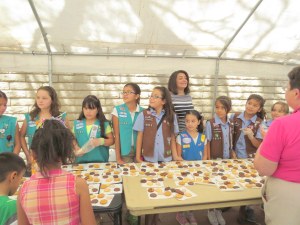 Girl Scouts serve cookies to clients and their families.